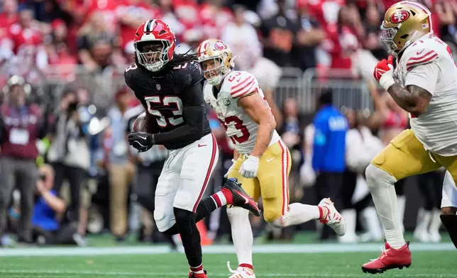 Atlanta Falcons linebacker Kendal Daniels (53) returns an interception as San Francisco 49ers running back Christian McCaffrey (23) and Trent Williams, right, give chase during the second half of an NFL football game in Atlanta, Sunday, Oct. 25, 2026. (AP Photo/Mike Stewart)