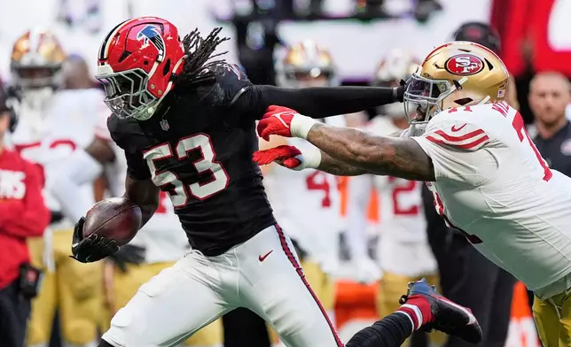 Atlanta Falcons linebacker Kendal Daniels (53) returns an interception as San Francisco 49ers offensive tackle Trent Williams, right, makes the stop during the second half of an NFL football game in Atlanta, Sunday, Oct. 25, 2026. (AP Photo/Mike Stewart)