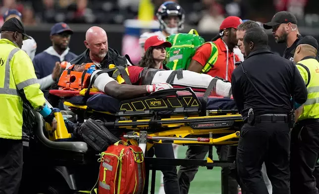 Atlanta Falcons linebacker Kendal Daniels is taken off the field after being injured during the second half of an NFL football game between the Falcons and the Chicago Bears in Atlanta, Sunday, Oct. 18, 2026. (AP Photo/Mike Stewart)