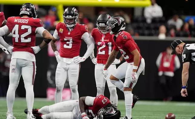 Atlanta Falcons linebacker Kendal Daniels (53) lies on the field after being injured during the second half of an NFL football game between the Falcons and the Chicago Bears in Atlanta, Sunday, Oct. 18, 2026. (AP Photo/Mike Stewart)