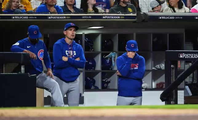 Chicago Cubs manager Craig Counsell, right, reacts in the dugout in the eighth inning of Game 2 of the National League Wild Card baseball playoff series against the San Diego Padres Wednesday, Sept. 30, 2026, in San Diego. (AP Photo/Gregory Bull)