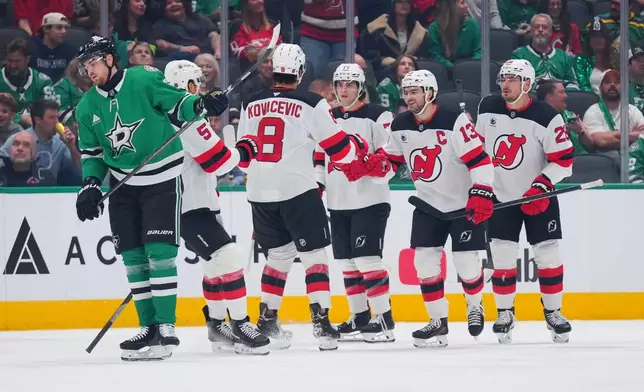 New Jersey Devils center Nico Hischier (13) celebrates after scoring a goal against the Dallas Stars during the first period of an NHL hockey game Tuesday, Oct. 27, 2026, in Dallas. (AP Photo/Julio Cortez)