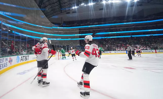 New Jersey Devils center Nico Hischier (13) celebrates his second period goal with teammates during an NHL hockey game against the Dallas Stars, Tuesday, Oct. 27, 2026, in Dallas. (AP Photo/Julio Cortez)