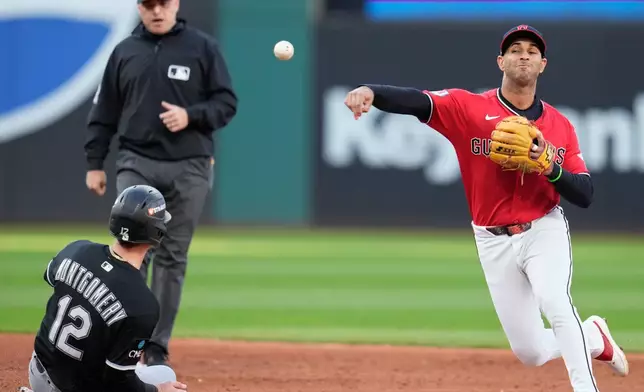 Cleveland Guardians shortstop Brayan Rocchio, right, forces out Chicago White Sox's Colson Montgomery (12) on a double play ball hit by Sam Antonacci in the third inning of Game 2 of baseball's American League Division Series in Cleveland, Monday, Oct. 5, 2026. (AP Photo/Sue Ogrocki)