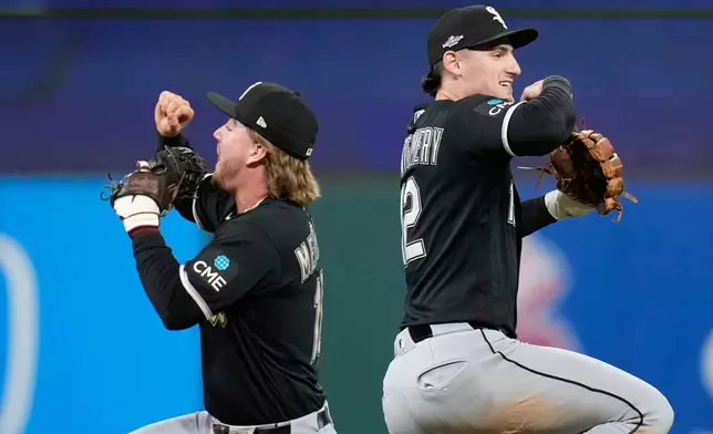 Chicago White Sox's Chase Meidroth, left, and Colson Montgomery, right, celebrate after Game 2 of baseball's American League Division Series against the Cleveland Guardians, Monday, Oct. 5, 2026, in Cleveland. (AP Photo/Sue Ogrocki)