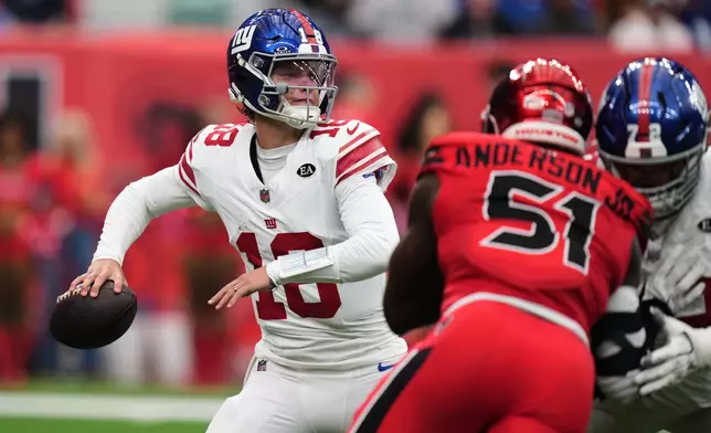 New York Giants quarterback J.J. McCarthy (18) throws a pass under pressure by Houston Texans defensive end Will Anderson Jr. (51) during the first half of an NFL football game in Houston, Sunday, Oct. 25, 2026. (AP Photo/Eric Smith)