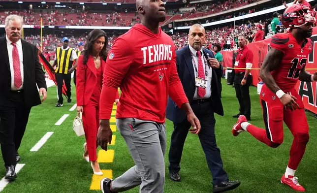 Houston Texans head coach DeMeco Ryans, center, walks off the field following an overtime loss to the New York Giants in an NFL football game in Houston, Sunday, Oct. 25, 2026. (AP Photo/Eric Smith)