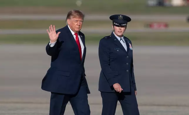 President Donald Trump walks to Air Force One with Air Force Col. Melissa Dombrock, deputy commanders, 89th Airlift Wing, at Joint Base Andrews, Md., Wednesday, Oct. 21, 2026. (AP Photo/Cliff Owen)
