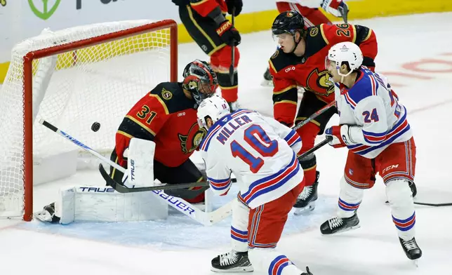 New York Rangers' J.T. Miller (10) scores on Ottawa Senators goaltender Jonas Johansson (31) as Senators' Carter Yakemchuk (26) and Rangers' Tye Kartye (24) look on during second period NHL hockey action in Ottawa on Saturday, Oct. 24, 2026. (Patrick Doyle/The Canadian Press via AP)