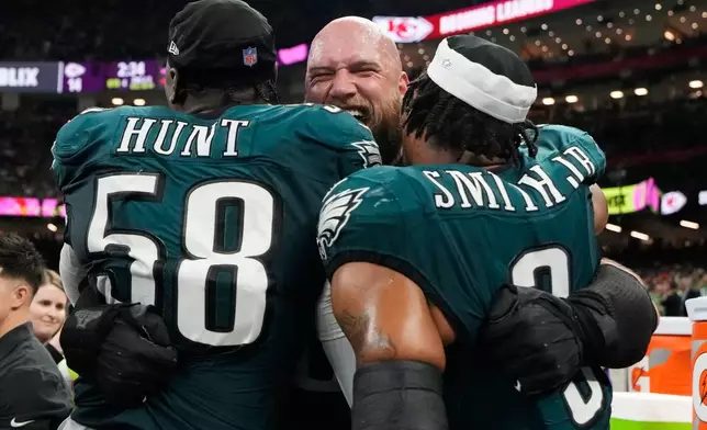 FILE - Philadelphia Eagles offensive tackle Lane Johnson, center, celebrates with linebacker Jalyx Hunt (58) and linebacker Nolan Smith Jr. (3) during the second half of the NFL Super Bowl 59 football game against the Kansas City Chiefs, Feb. 9, 2025, in New Orleans. (AP Photo/Brynn Anderson, File)
