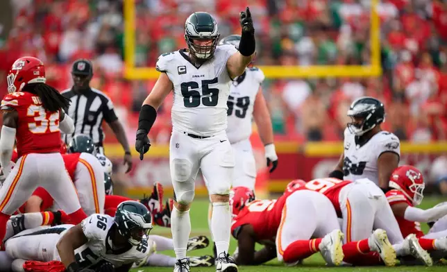 FILE - Philadelphia Eagles offensive tackle Lane Johnson (65) signals a first down after a successful tush push near the end of an NFL football game against the Kansas City Chiefs, Sept. 14, 2025, in Kansas City, Mo. (AP Photo/Reed Hoffmann, File)