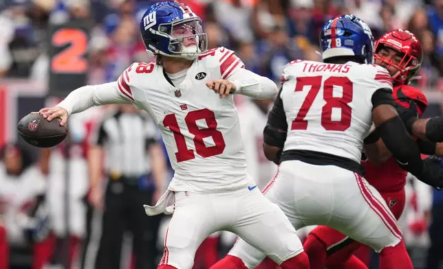 New York Giants quarterback J.J. McCarthy (18) looks to throw a pass during the first half of an NFL football game against the Houston Texans in Houston, Sunday, Oct. 25, 2026. (AP Photo/Eric Smith)