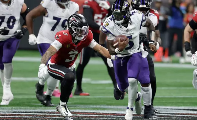 Baltimore Ravens quarterback Tyler Huntley (5) runs from Atlanta Falcons safety Jessie Bates III (3) during the first half of an NFL football game, Sunday, Oct. 11, 2026, in Atlanta. (AP Photo/Erik S. Lesser)