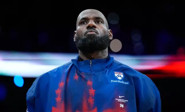 Philadelphia 76ers' LeBron James stands before a preseason NBA basketball game against the Boston Celtics Friday, Oct. 16, 2026, in Philadelphia. (AP Photo/Matt Slocum)