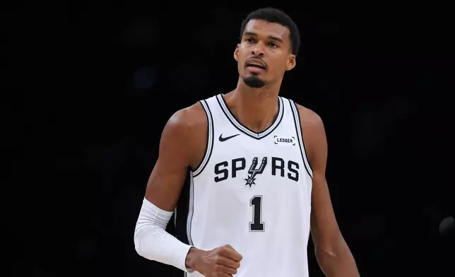 San Antonio Spurs forward Victor Wembanyama (1) reacts to a play during the first half of a preseason NBA basketball game against the Sacramento Kings in San Antonio, Friday, Oct. 16, 2026. (AP Photo/Eric Gay)