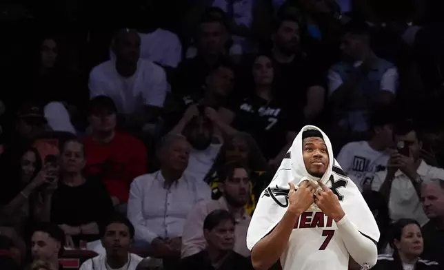 Miami Heat forward Giannis Antetokounmpo watches from the bench in the final minutes of an NBA preseason basketball game against the Brooklyn Nets, Wednesday, Oct. 14, 2026, in Miami. (AP Photo/Rebecca Blackwell)