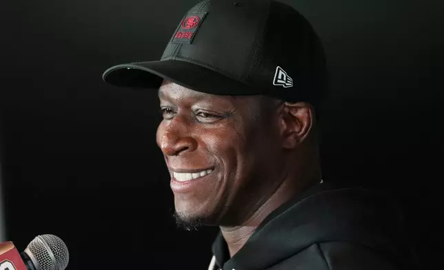 FILE - San Francisco 49ers defensive coordinator Raheem Morris speaks to the media ahead of practice, Sept. 8, 2026, in Melbourne, Australia. (AP Photo/Asanka Brendon Ratnayake, File)