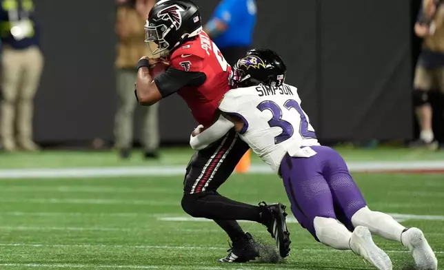 Atlanta Falcons quarterback Michael Penix Jr. (9) is tackled by Baltimore Ravens linebacker Trenton Simpson (32) during the second half of an NFL football game, Sunday, Oct. 11, 2026, in Atlanta. (AP Photo/Mike Stewart)