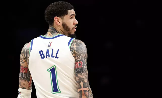 Minnesota Timberwolves guard LaMelo Ball (1) looks on during the first half of a preseason NBA basketball game against the Detroit Pistons Wednesday, Oct. 14, 2026, in Minneapolis. (AP Photo/Matt Krohn)