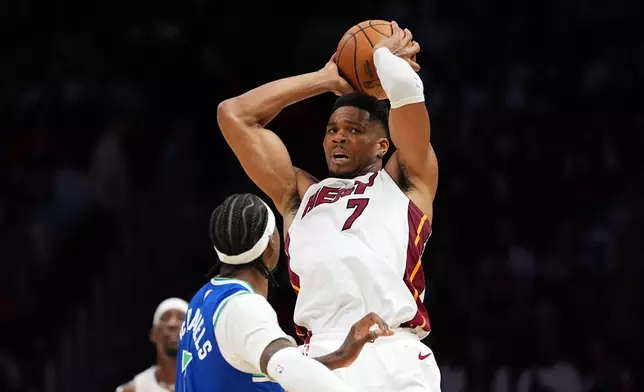 Miami Heat forward Giannis Antetokounmpo (7) looks for an opening past Minnesota Timberwolves forward Jaden McDaniels during the first half of an NBA basketball game, Wednesday, Oct. 21, 2026, in Miami. (AP Photo/Rebecca Blackwell)