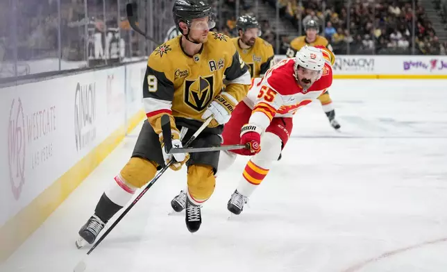 Vegas Golden Knights center Jack Eichel (9) skates around Calgary Flames defenseman Jake Middleton (55) during the second period of an NHL hockey game Thursday, Oct. 15, 2026, in Las Vegas. (AP Photo/John Locher)