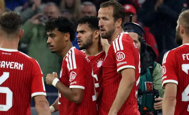 Bayern's Harry Kane, centre right, celebrates with teammates after scoring their side's fifth goal of the game during the Bundesliga soccer match between Bayern Munich and Leipzig, in Munich, Germany, Saturday Oct. 17, 2026. (Karl-Josef Hildenbrand/dpa via AP)