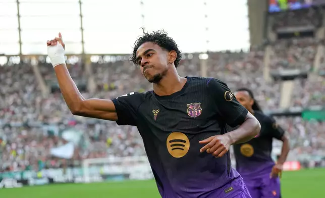Barcelona's Lamine Yamal celebrates after scoring his side's opening goal during the Spanish La Liga soccer match between Real Betis and Barcelona in Seville, Spain, Saturday, Oct. 17, 2026. (AP Photo/Jose Breton)
