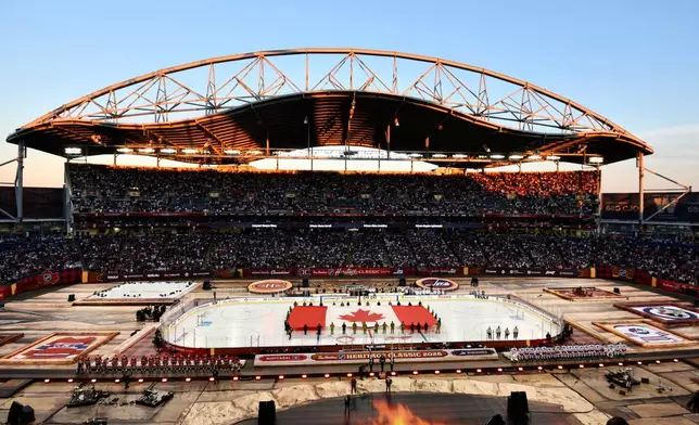 A Canadian flag is unfurled at Princess Auto Stadium before the NHL Heritage Classic hockey game between the Winnipeg Jets and the Montreal Canadiens in Winnipeg, Manitoba, Sunday, Oct. 25, 2026. (Fred Greenslade/The Canadian Press via AP)