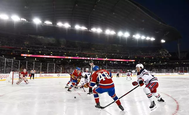 The Winnipeg Jets and the Montreal Canadiens play during the first period of the NHL Heritage Classic hockey game in Winnipeg, Manitoba, Sunday, Oct. 25, 2026. (Fred Greenslade/The Canadian Press via AP)