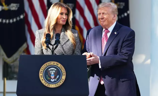 President Donald Trump, with first lady Melania Trump, attends an event about women's health, in the Rose Garden of the White House, Monday, Oct. 19, 2026, in Washington. (AP Photo/Mark Schiefelbein)