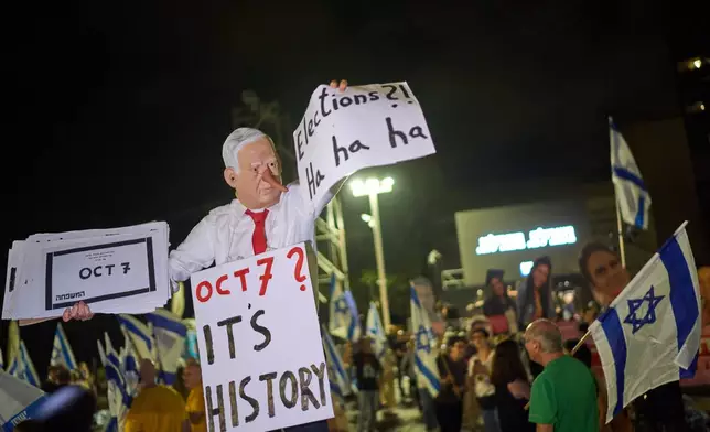 A demonstrator wearing a mask depicting Prime Minister Benjamin Netanyahu attends an anti-government rally ahead of the country's general election, Saturday, Oct. 24, 2026, in Tel Aviv, Israel. (AP Photo/David Goldman)