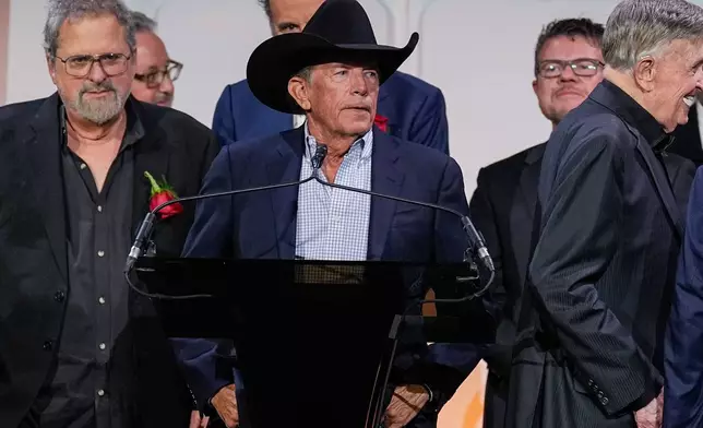 George Strait, center, speaks during the Nashville Songwriters Hall of Fame Gala on Monday, Oct. 26, 2026, at the Music City Center in Nashville, Tenn. (AP Photo/George Walker IV)