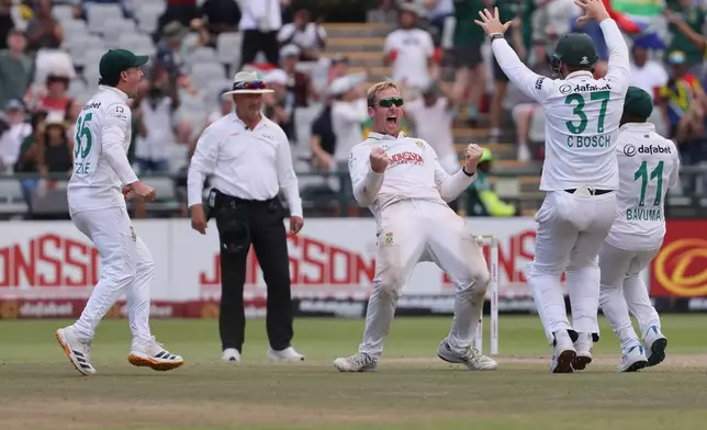 South Africa's Simon Harmer celebrates his seventh wicket of the match during the fifth day of the third cricket test match between South Africa and Australia in Cape Town, South Africa, Saturday, Oct. 31, 2026. (AP Photo/Halden Krog)