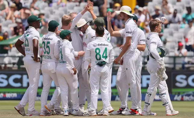 South Africans celebrate the wicket of Australia's Mitchell Starc, on day five of the third cricket test match between South Africa and Australia, in Cape Town, South Africa, Saturday, Oct. 31, 2026. (AP Photo/Halden Krog)
