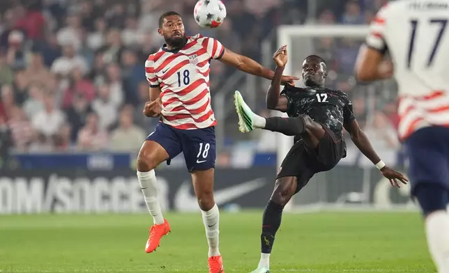 United States' George Campbell (18) and Canada's Tani Oluwaseyi (12) battle for possession of the ball during the first half of an international friendly soccer match Tuesday, Oct. 6, 2026, in St. Paul, Minn. (AP Photo/Abbie Parr)