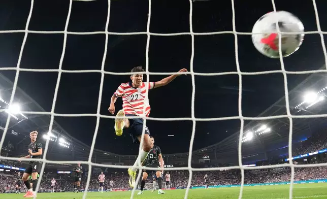 United States' Justin Ellis (22) scores a goal during the first half of an international friendly soccer match against Canada Tuesday, Oct. 6, 2026, in St. Paul, Minn. (AP Photo/Abbie Parr)