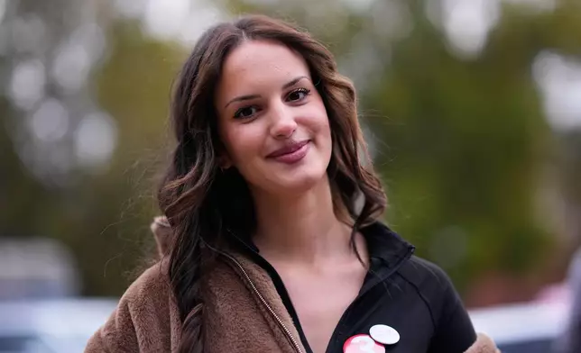 Andjela Radojevic, student of business, from Belgrade, 25, poses for a photo ahead of the election in Belgrade, Serbia, Thursday, Oct. 22, 2026. (AP Photo/Petr David Josek)