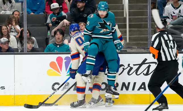 San Jose Sharks left wing Kiefer Sherwood (44) collides with Edmonton Oilers right wing Vasily Podkolzin (92) during the second period of an NHL hockey game in San Jose, Calif., Saturday, Oct. 10, 2026. (AP Photo/Tony Avelar)