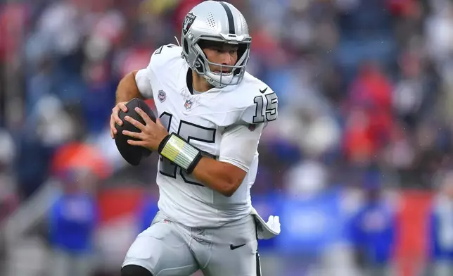 Las Vegas Raiders quarterback Fernando Mendoza runs with the ball during the second half of an NFL football game against the New England Patriots in Foxborough, Mass., Sunday, Oct. 11, 2026. (AP Photo/Steven Senne)