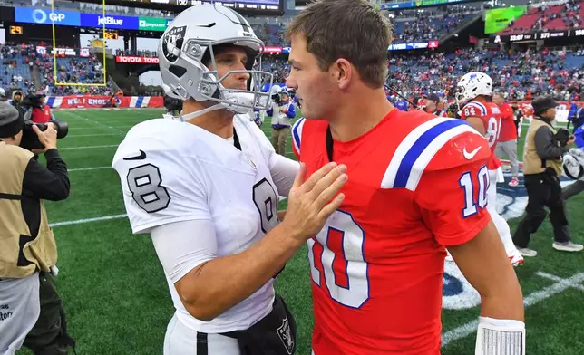 New England Patriots quarterback Drake Maye (10) greets Las Vegas Raiders quarterback Kirk Cousins (8) after an NFL football game in Foxborough, Mass., Sunday, Oct. 11, 2026. (AP Photo/Steven Senne)