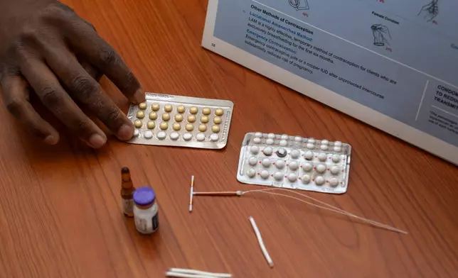 Women are shown birth control choices that the Marie Stopes reproductive health organization offers in Lusaka, Zambia, Tuesday, Sept. 8, 2026. (AP Photo/Anita Reed)