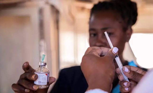 A health worker prepares an anesthetic injection inside a caravan at Epworth Poly Clinic in Epworth, Zimbabwe, Tuesday, Aug. 25, 2026. (AP Photo/Aaron Ufumeli)