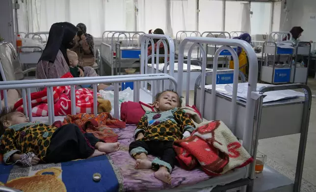 Afghan women care for their children in the malnutrition ward at Indira Gandhi children's hospital in Kabul, Afghanistan, Monday, Oct. 12, 2026. (AP Photo/Siddiqullah Alizai)