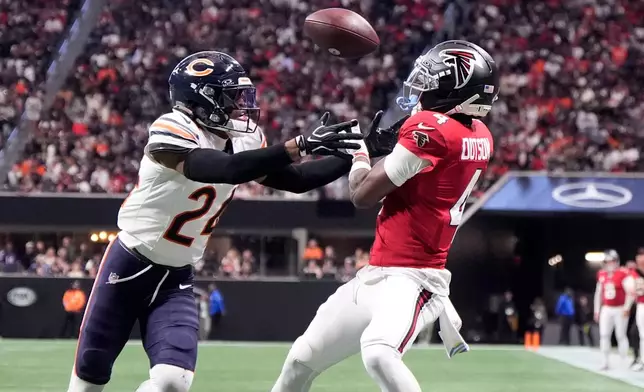 Atlanta Falcons wide receiver Jahan Dotson (4) catches a touchdown pass ahead of Chicago Bears cornerback Malik Muhammad (24) during the first half of an NFL football game in Atlanta, Sunday, Oct. 18, 2026. (AP Photo/Mike Stewart)
