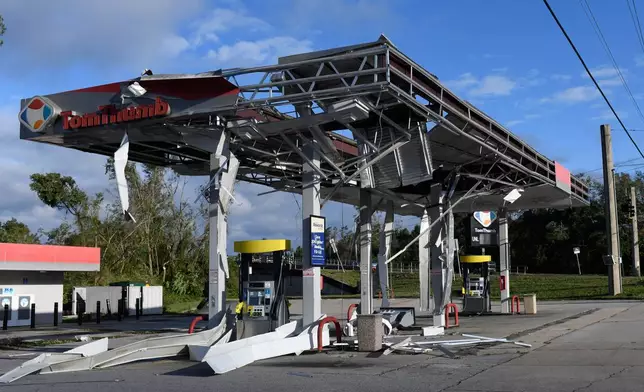 A gas station is damaged by the effects of Isaias on Saturday, Oct. 10, 2026, in East Milton, Fla. (AP Photo/Octavio Jones)