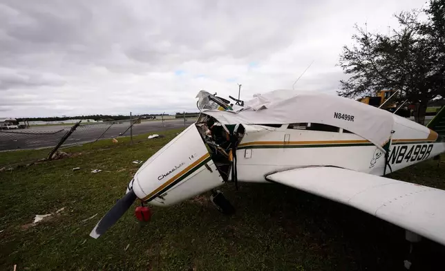 A damaged airplane is seen at Peter Prince Field in the aftermath of Hurricane Isaias in Milton, Fla., Saturday, Oct. 10, 2026. (AP Photo/Gerald Herbert)