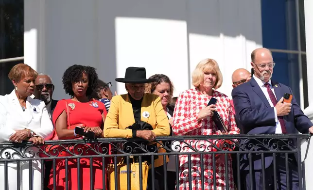 Gold Star family members stand on the Blue room Balcony before President Donald Trump departs on Marine One from the South Lawn of the White House, Tuesday, Oct. 6, 2026, in Washington. (AP Photo/Alex Brandon)