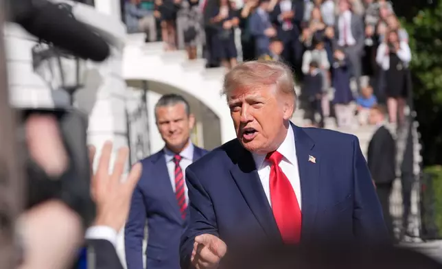 President Donald Trump speaks with reporters before departing on Marine One from the South Lawn of the White House, Tuesday, Oct. 6, 2026, in Washington, as Defense Secretary Pete Hegseth and Gold Star families watch. (AP Photo/Alex Brandon)