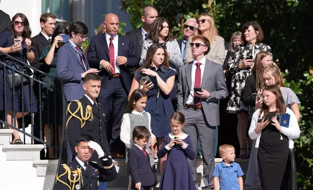 Gold Star family members stand on steps leading down from the Blue Room Balcony before President Donald Trump departs on Marine One from the South Lawn of the White House, Tuesday, Oct. 6, 2026, in Washington. (AP Photo/Alex Brandon)
