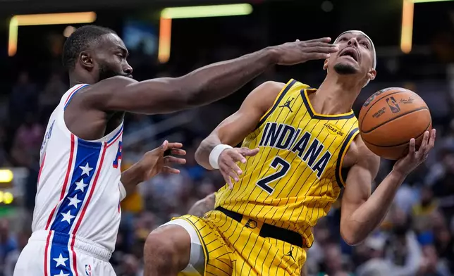 Indiana Pacers guard Andrew Nembhard (2) shoots in front of Philadelphia 76ers guard Jaylen Brown (7) during the first half of an NBA basketball game in Indianapolis, Wednesday, Oct. 28, 2026. (AP Photo/Michael Conroy)